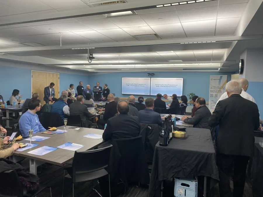 A full room of attendees watching a panel at an industry session